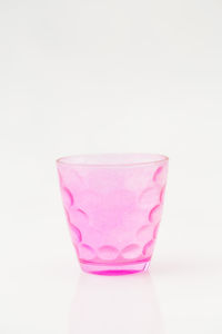Close-up of pink glass against white background