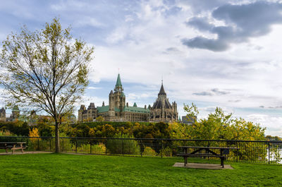 View of trees and buildings against sky