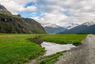 Scenic view of lake and mountains against sky