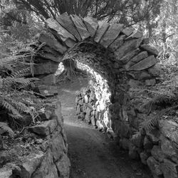 Footpath amidst rocks in tunnel