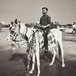 Portrait of man riding horse