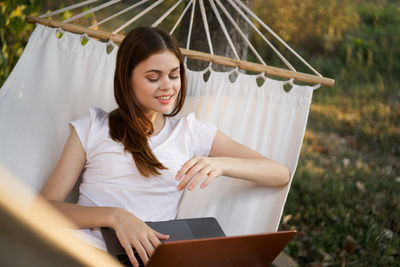 Portrait of young woman using digital tablet