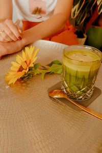 Midsection of woman sitting on table