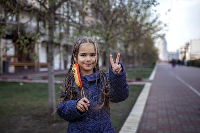 Portrait of girl standing on street