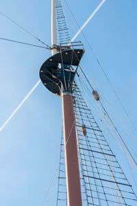 Low angle view of ship mast against clear blue sky