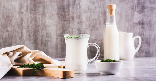 Ayran homemade yogurt drink with dill in a glass on the table web banner