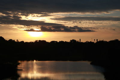 Scenic view of lake against romantic sky at sunset