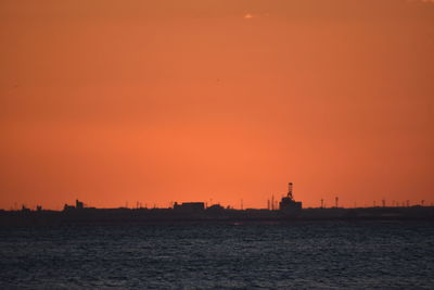 Scenic view of sea against orange sky