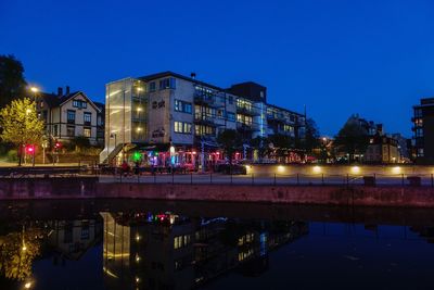 Reflection of illuminated buildings in lake at night