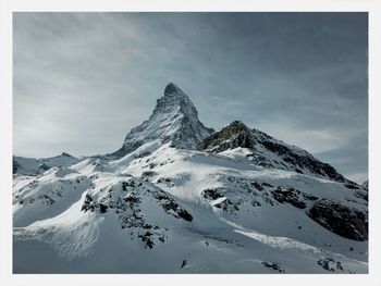 Scenic view of snow covered mountains against sky