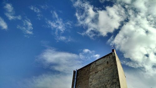 Low angle view of building against cloudy sky