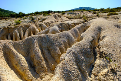 Panoramic view of rocks on land against sky