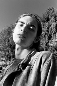 Low angle portrait of man standing against sky