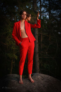 Full length of woman standing in forest