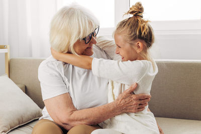 Side view of mother and daughter at home