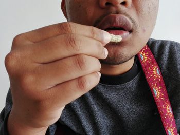 Close-up of man holding cigarette