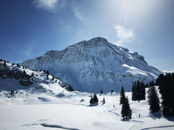 Scenic view of snowcapped mountains against sky