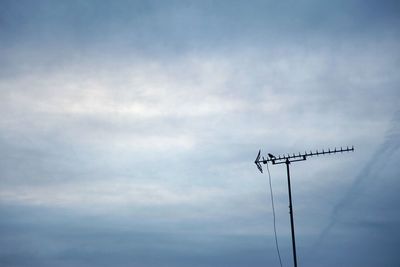 Low angle view of telephone pole against sky