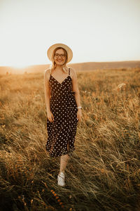 Portrait of woman standing on field