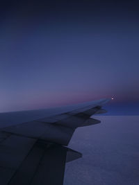 Cropped image of airplane flying over clouds