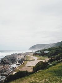 Scenic view of sea and cliff against sky