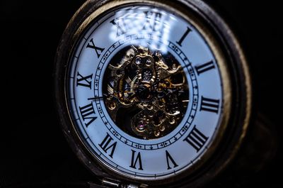 Close-up of clock against black background