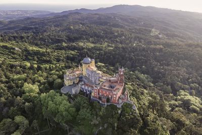 High angle view of trees and buildings against mountains