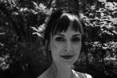 Portrait of woman against plants