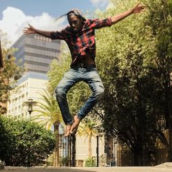 Full length of young man against plants