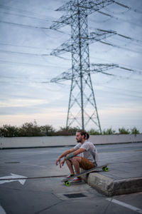 Boy posing with skateboard in hand