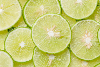 Limes slices texture background, close up, top view