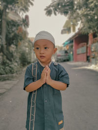 Portrait of boy standing on road