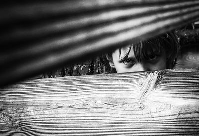 Portrait of girl looking through fence