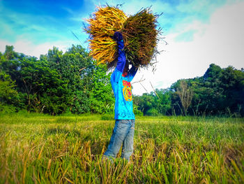 Rear view of woman standing in field