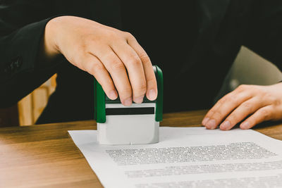 Close-up of person hand on table