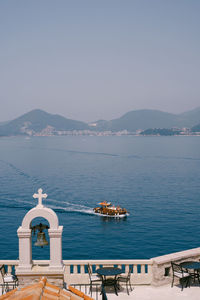 Boats in sea against clear sky