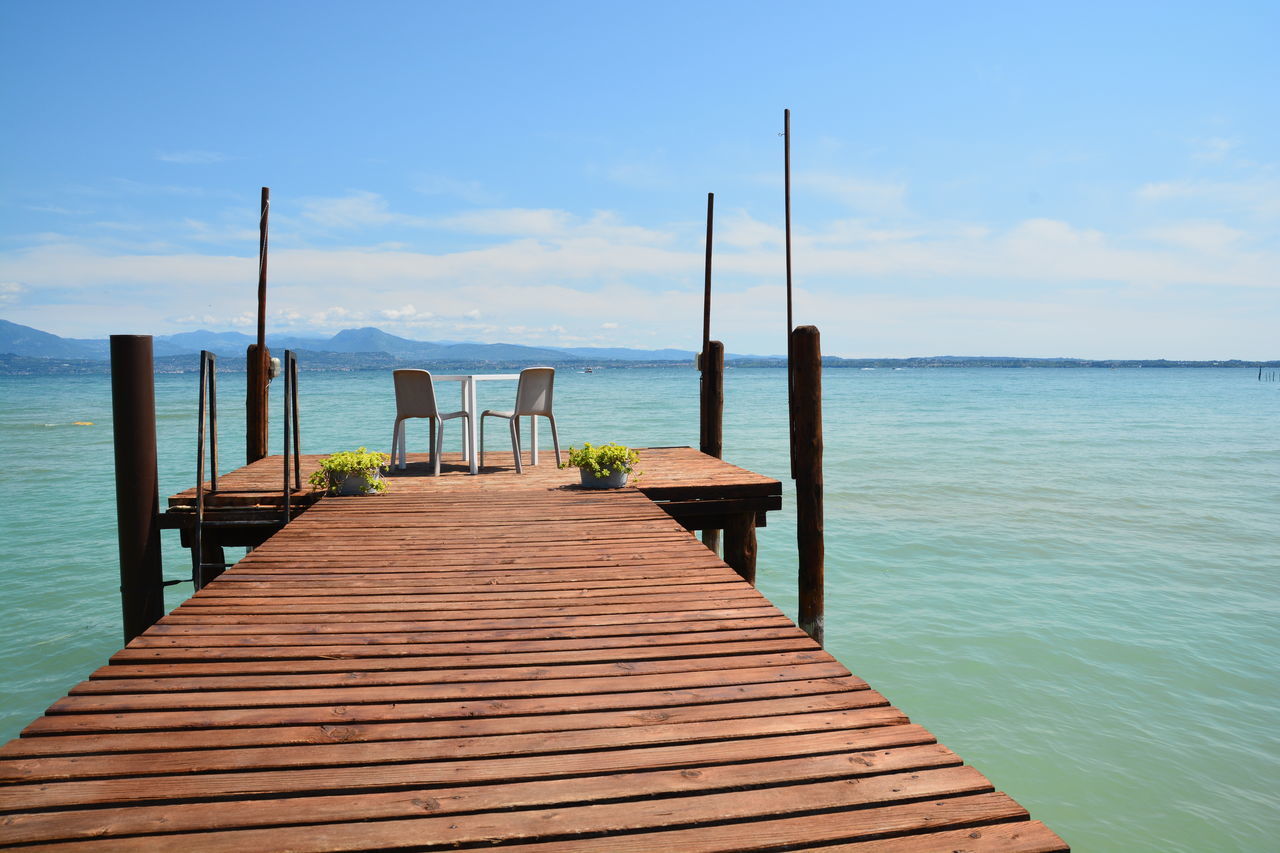 PIER LEADING TOWARDS SEA AGAINST SKY