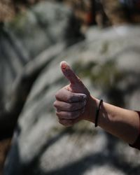 Cropped hand showing thumbs up
