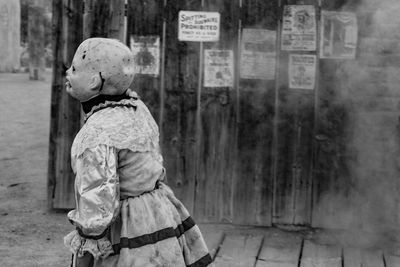 Close-up of woman standing against wall