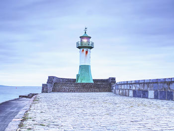 Lighthouse tower on stony mole in sasssnitz town port. lighthouse at harbour entrance in sassnitz.