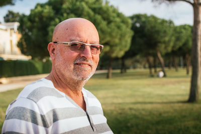 Portrait of 65-year-old man in a park