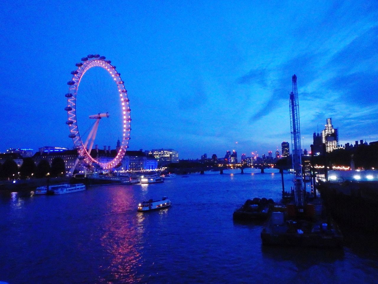 ILLUMINATED FERRIS WHEEL AT DUSK