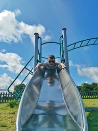 Portrait of boy on slide at playground