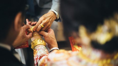 Close-up of hands holding cross