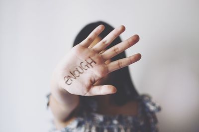 Close-up of woman hand with text against white background