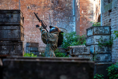 Rear view of man standing against wall