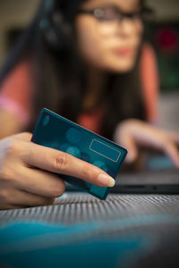 Midsection of woman using mobile phone
