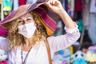Portrait of woman wearing mask at market stall