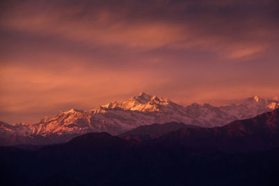 Scenic view of snowcapped mountains against sky during sunset