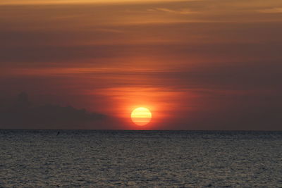 Scenic view of sea against romantic sky at sunset